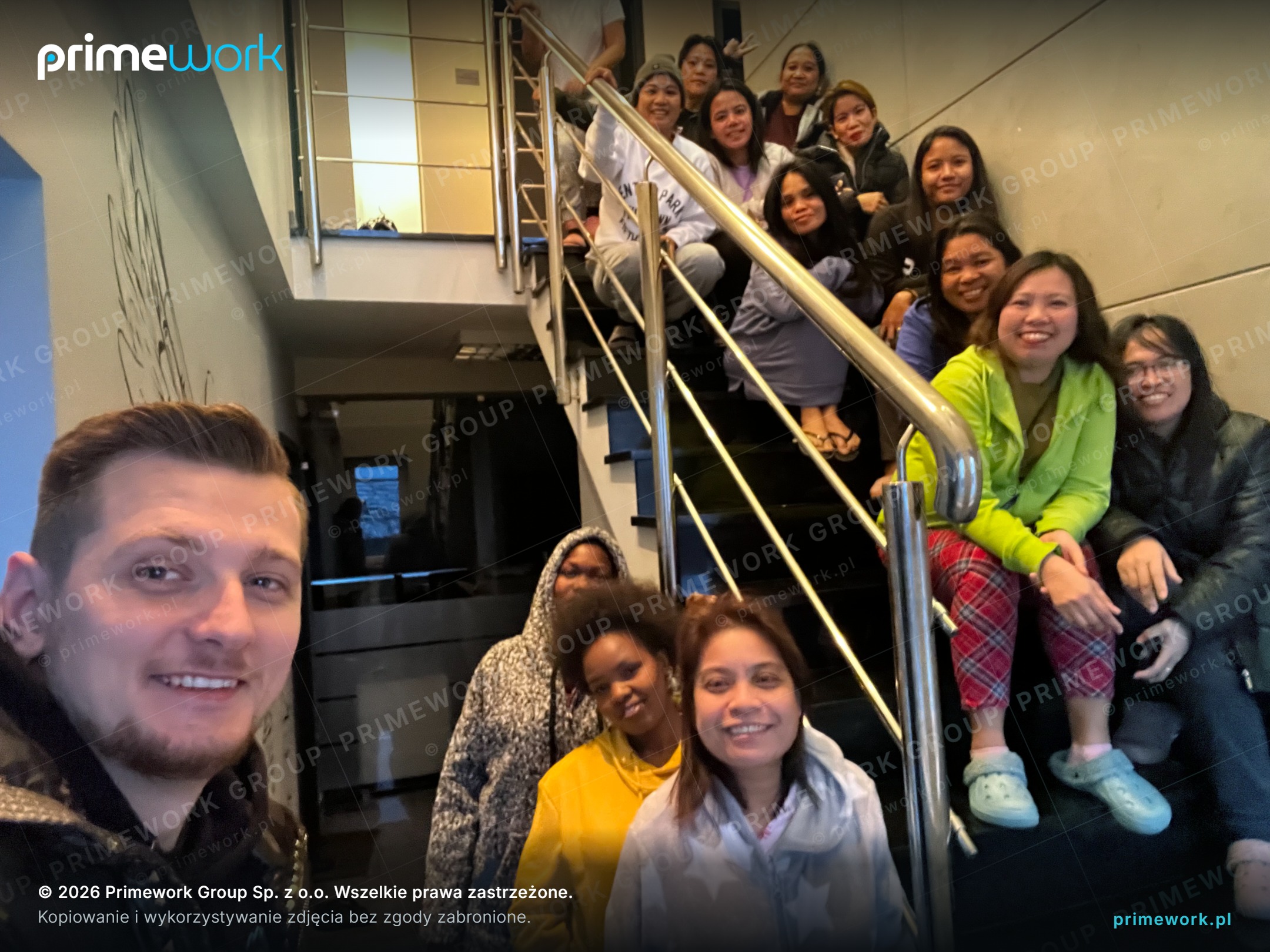 A group of foreign workers on the staircase of a building with worker flats