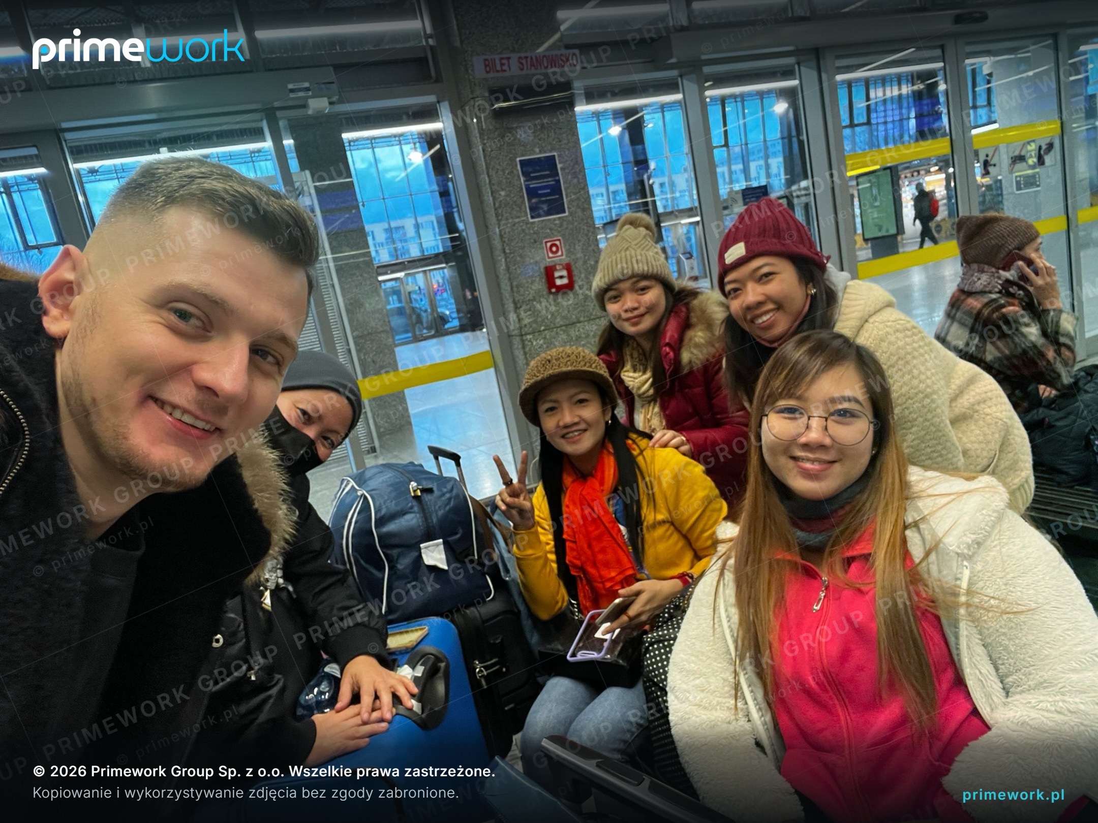 A Primework coordinator with a group of Asian workers during transport to the workplace