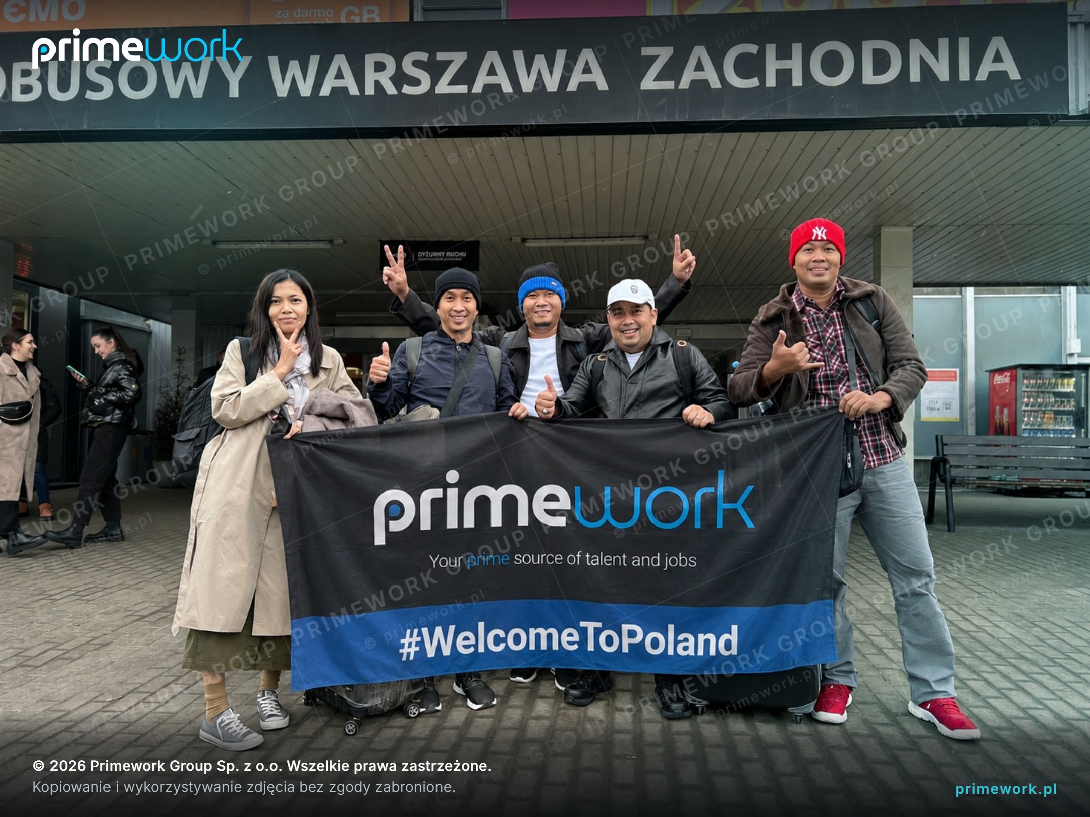 Filipino workers with a Primework banner at Warszawa Zachodnia bus station