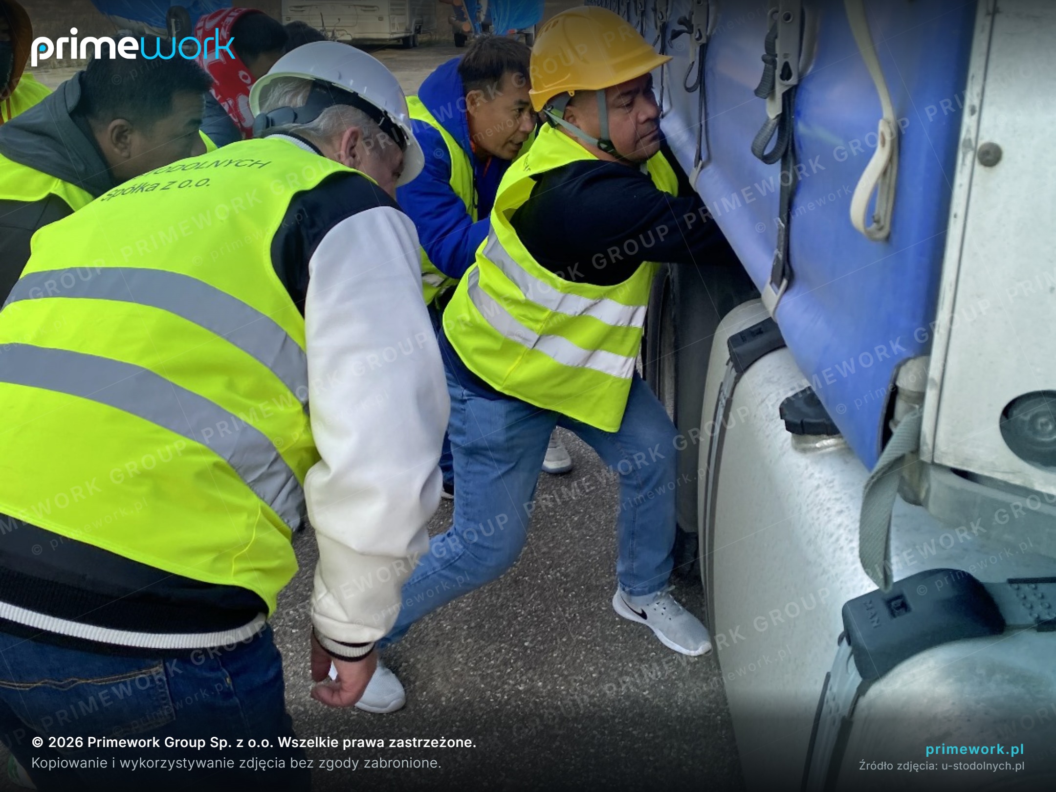 An instructor showing Asian drivers the tractor unit cab during training
