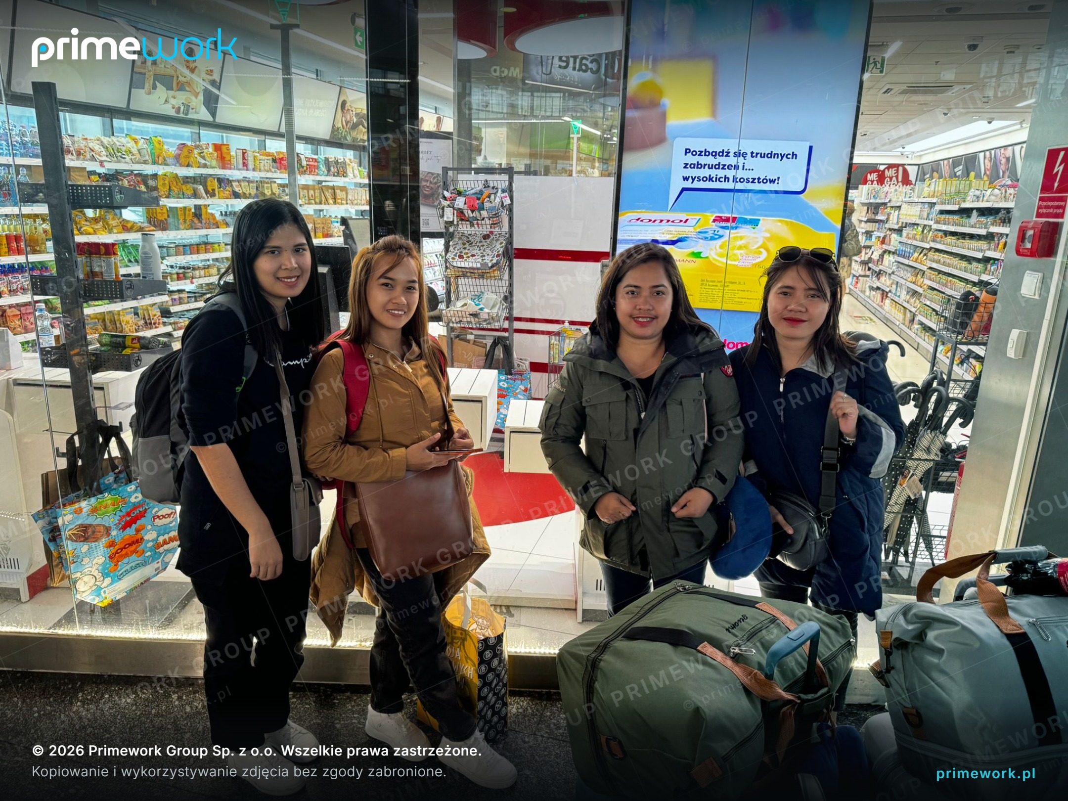 Women workers from Asia with luggage at a station on the way to their accommodation